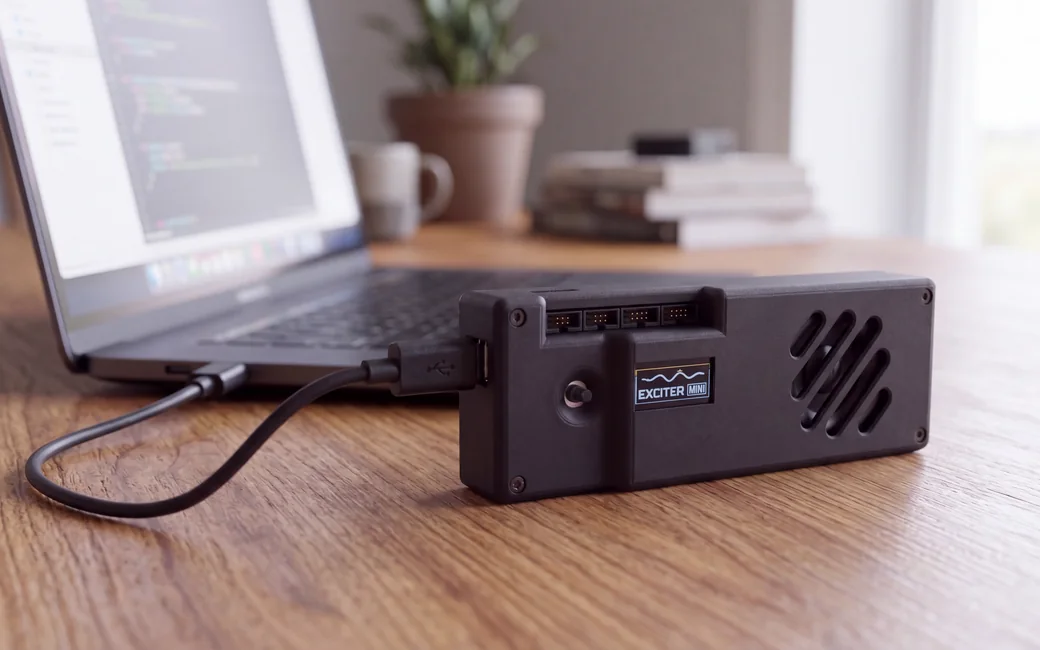 Exciter Mini connected to a laptop over USB-C on a desk
